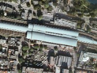 Aerial  Aerial view (by Google). The main entrance is on the south eastern edge of the station hall. The station consist of two major spans, extended to the west by a prolonged narrow span that houses two dead end tracks and a small span to the east (to Amsterdam)