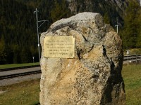 DSC00517  Start at Preda, immediately at the tunnel mouth of the Albula base tunnel. A small monument commemorates the harsh conditions under which railway lines in the mountains were constructed.   The sign says :   Building the Albula tunnel. Rock that killed 3 workers. 13 others also lost their lives. Their sacrifice will not be forgotten.