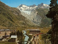 1970-gletsch-mit-rhonegletscher  -->  And this postcard from 1970 still shows the glacier hanging over the ridge. This is how I remember it from my 1970-1980 holidays in Switzerland. The postcard also show a regular Furka-Oberalp Bahn train leaving the station towards Andermatt in a time when the old line was still in commercial use.