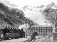 Gletsch oud  -->  An photo made from almost the same spot. Udated but before 1940 as the line was electrified during WWII. It shows how far the glacier reached down in the 1930s
